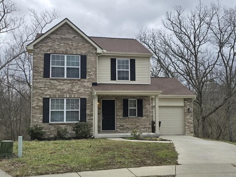 A two-story house with a garage on the side.